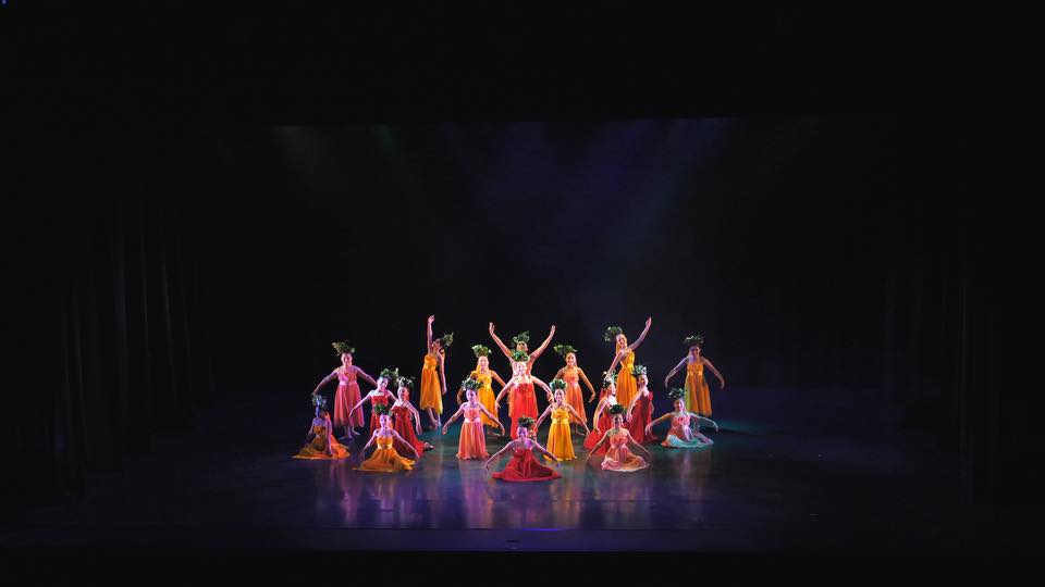 Students performing on stage at Into the spotlight dance festival